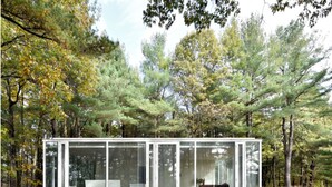 A modern glass house with a minimalist design, surrounded by a forest. - Modern Glass House designed by renowned architect Thomas Phifer (Hudson)
