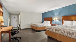 A hotel room with two beds, a desk, and a chair. - Americas Best Value Inn Carlisle (Carlisle)