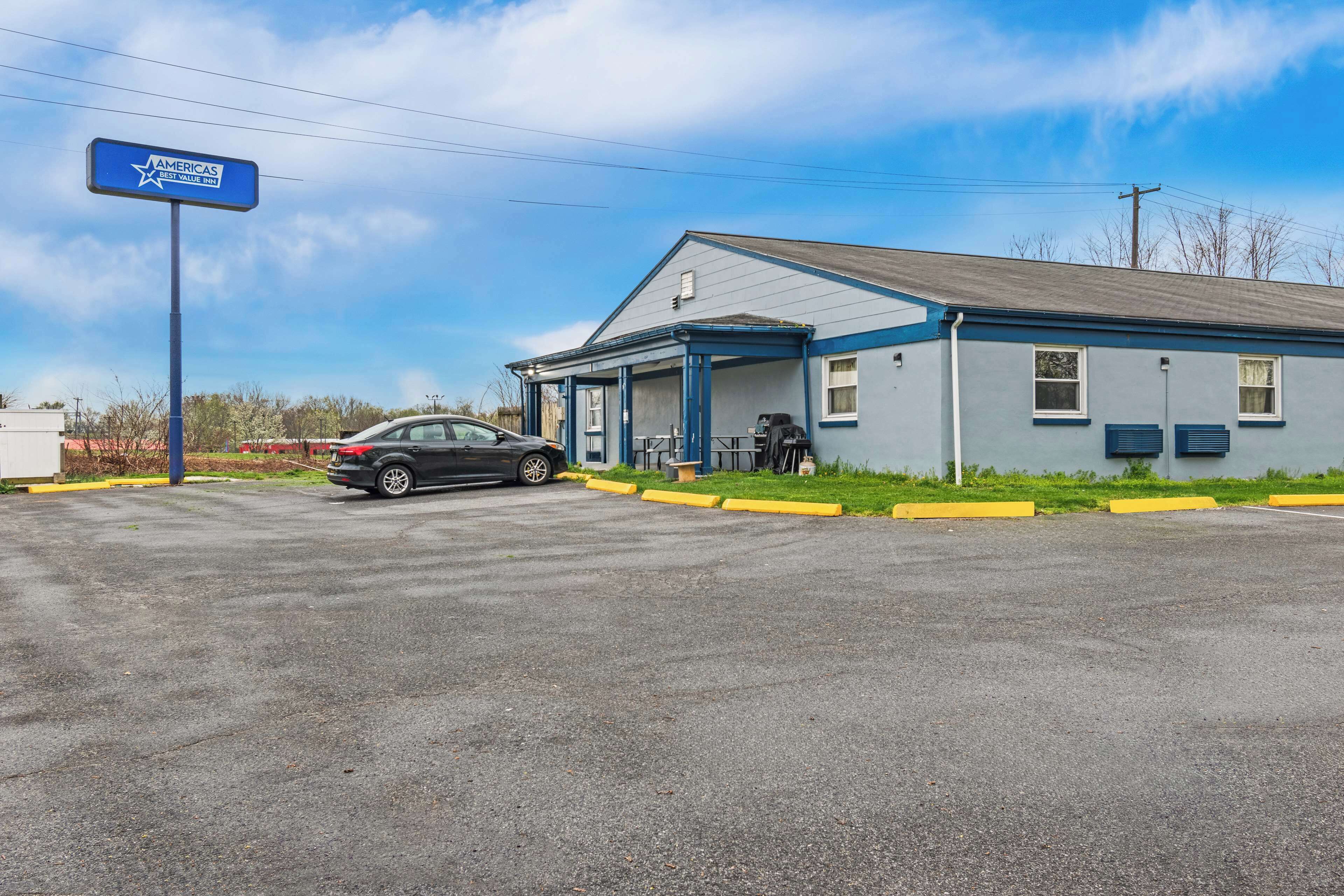 A single-story building with a blue exterior and a covered front porch.