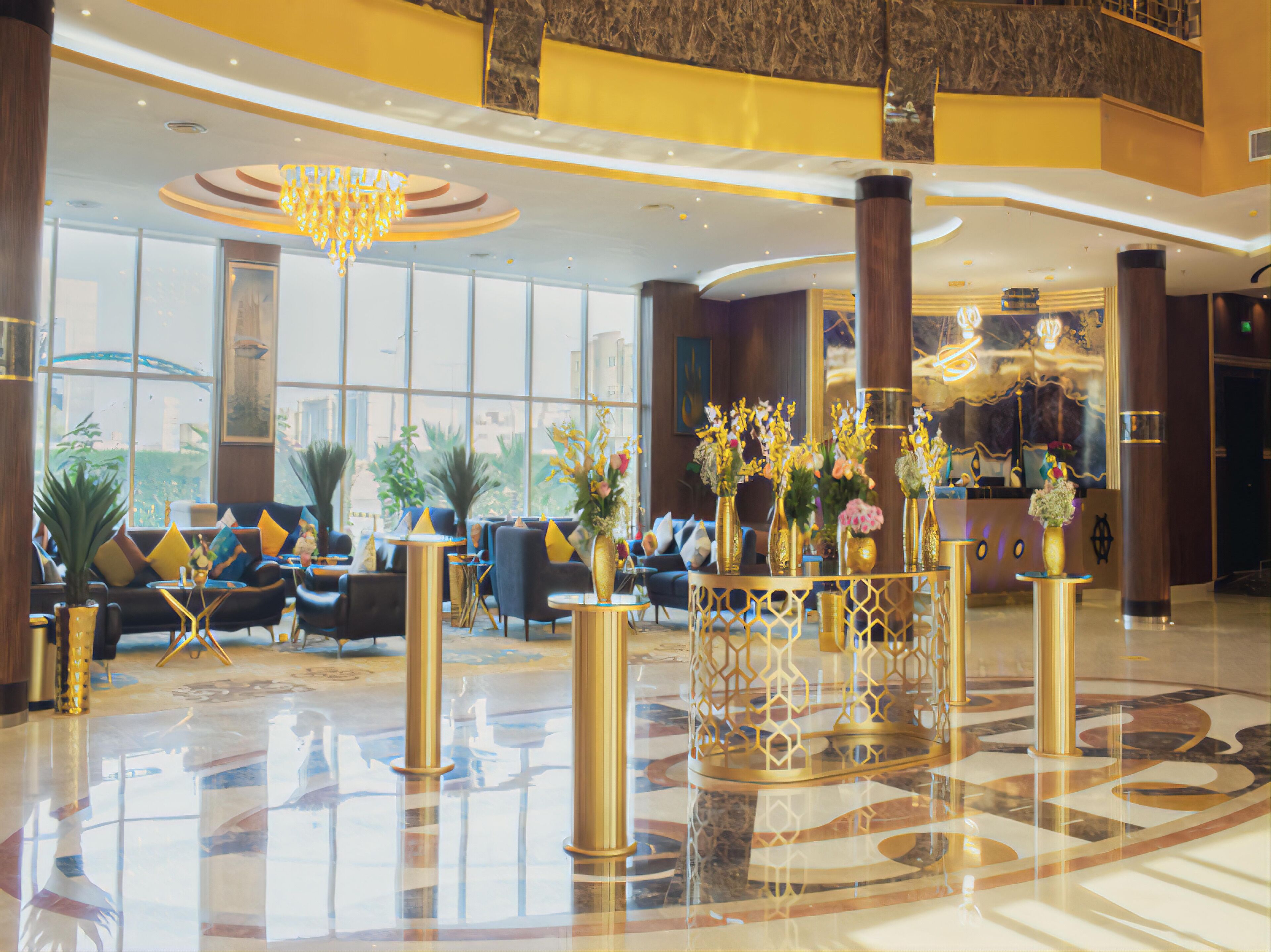 A spacious lobby with a central seating area, large windows, and a chandelier.