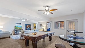 A spacious living area with a pool table, a ceiling fan, and a billiards table. - Peaceful 2BR Farm Stay - 10 Min To Grand Park (Sheridan)