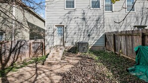 A two-story house with a front yard, a wooden fence, and a covered outdoor area. - SP1  20% OFF New 3BR Home for Families or Large Groups 5-mins from Methodist (San Antonio)