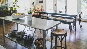 A spacious kitchen with a long island, wooden flooring, and a large window. - Healdsburg Homestead with Pool, Hot Tub and Tastings Included (Healdsburg)