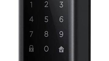 A black security keypad with a fingerprint scanner and a large button below the keypad.