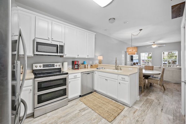Enjoy cooking in this well-lit kitchen with stainless steel appliances and a central island.
