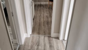 A hallway with a wooden floor and white walls. - Killarney Town Center (Killarney)