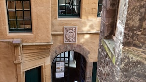 Ein Bogen führt zum Eingang eines Gebäudes, auf dem ein Schild für eine private Veranstaltung steht.