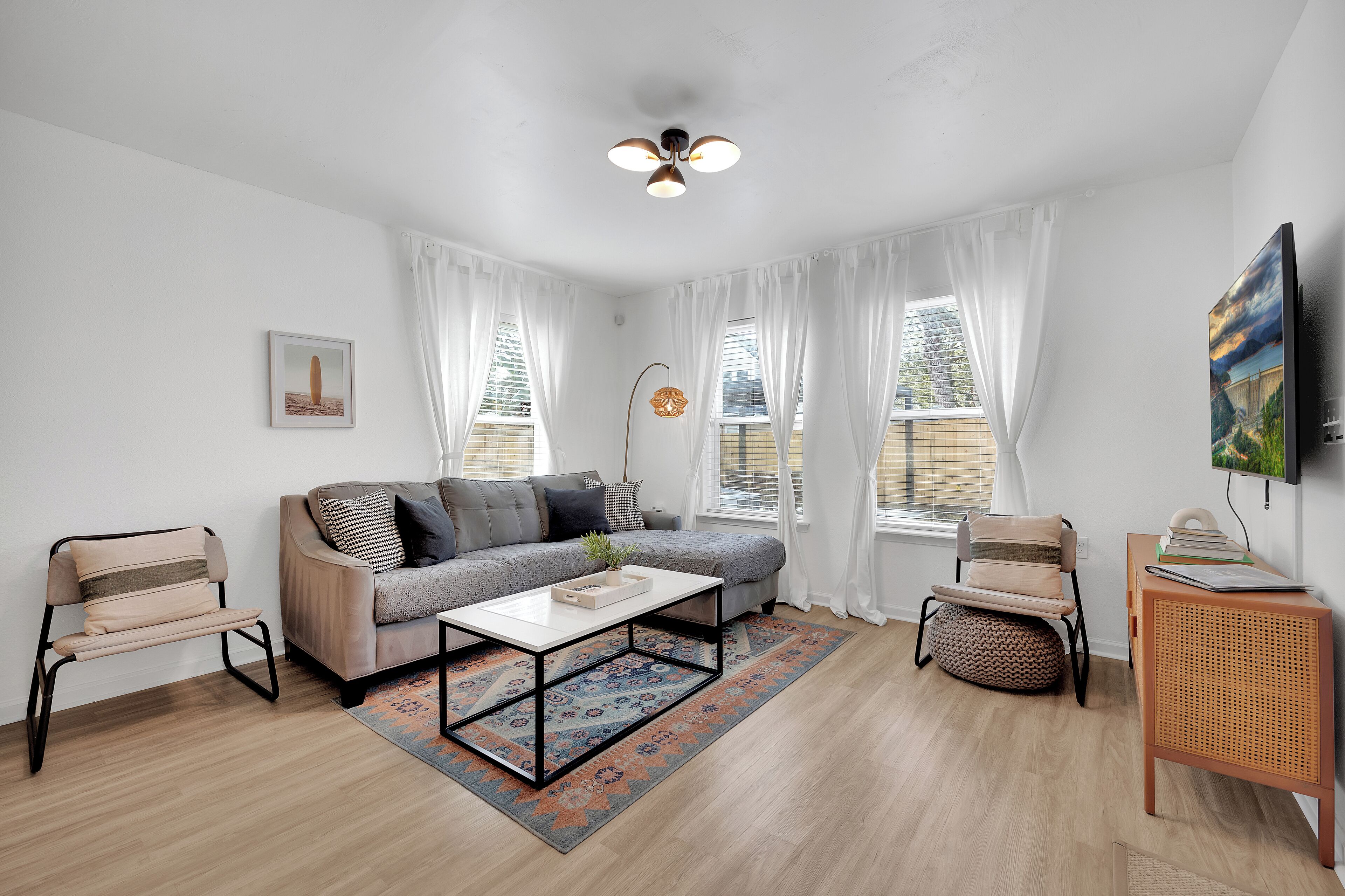 Una sala de estar moderna con sofá, mesa de centro y dos sillones.