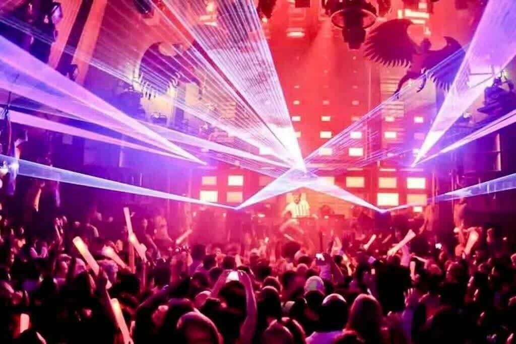 A crowded indoor space with a stage and audience.