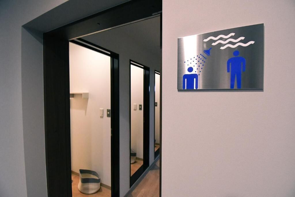 A hallway with a sign indicating a men's restroom.