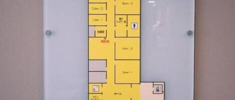 A floor plan with labeled rooms and amenities, including a reception area, restrooms, and a dining area.