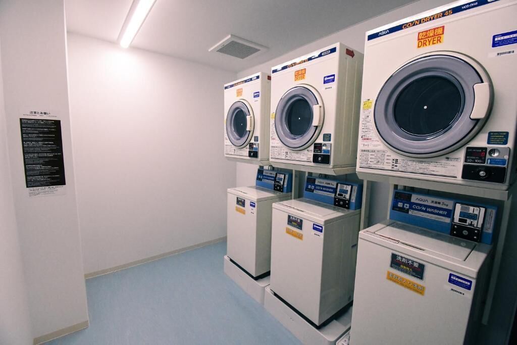 A laundry facility with multiple washing machines and dryers.