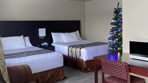 A hotel room with two beds, a desk, a chair, a Christmas tree, and a television. - Silver Maple Motel (Dysart et al)