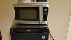 A compact black refrigerator with a built-in microwave on top. - Silver Maple Motel (Dysart et al)
