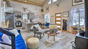 A spacious living area with a modern kitchen, a dining area, and a cozy seating arrangement. - 1 Mi to St Mary’s Glacier Trail: Modern Mtn Cabin! (Idaho Springs)