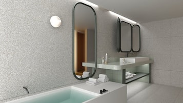 A modern bathroom with a freestanding bathtub, a vanity with a mirror, and a towel rack.