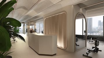 A modern office space with a reception desk, large windows, and a view of the city.