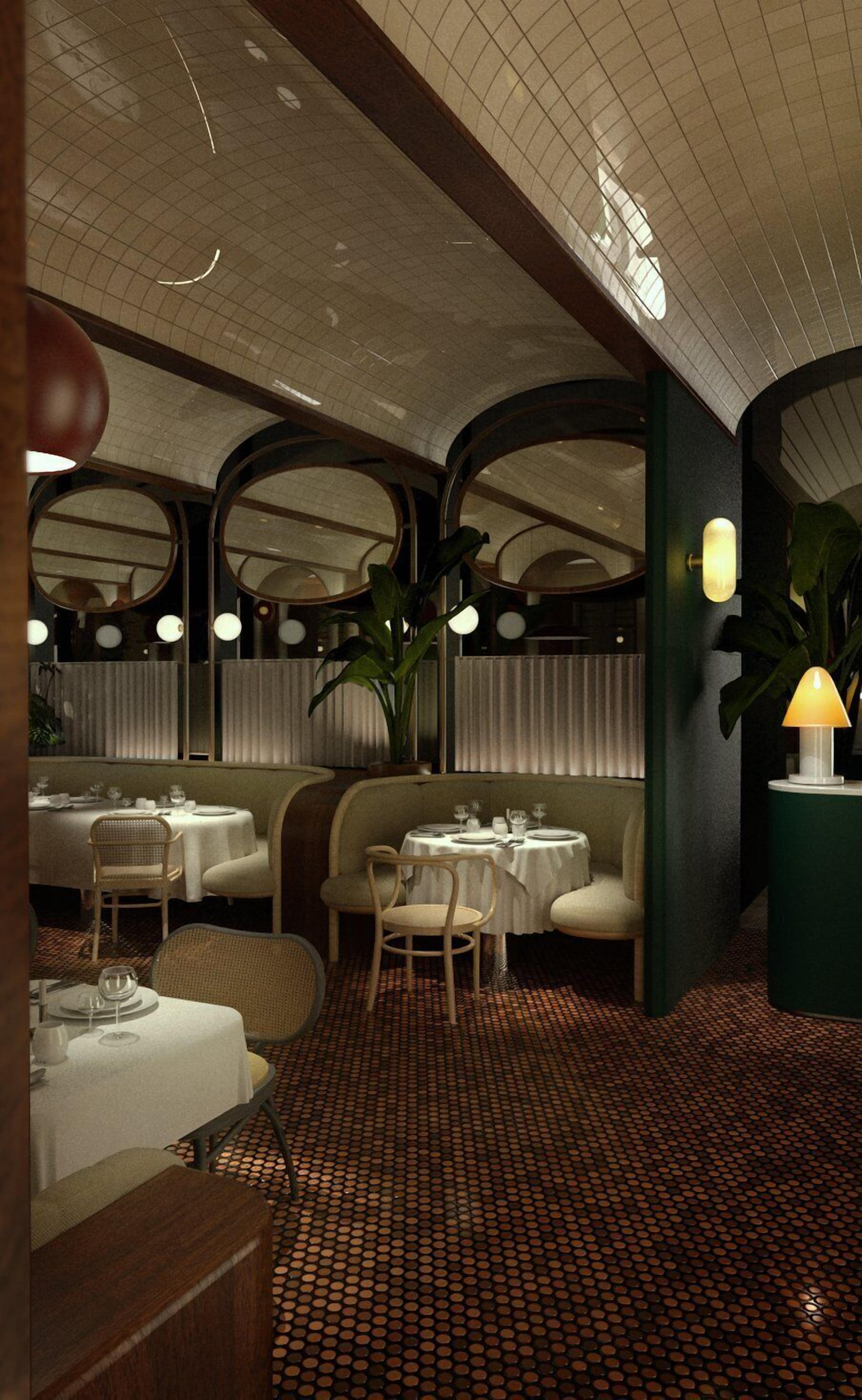 Interior de restaurante con mesas redondas, asientos acolchados y suelo estampado.