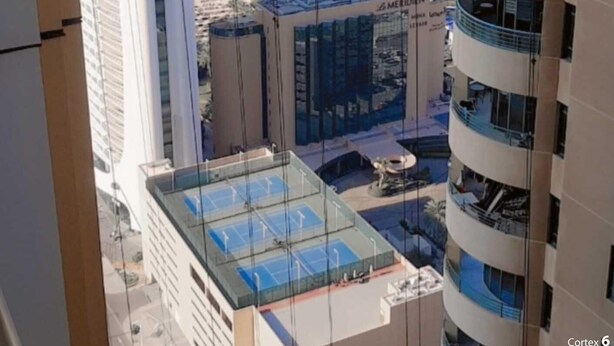 A high-rise building with a view of a marina and boats. - Luxury Private Room in an Apartment Next to Barasti Beach  (Dubai)