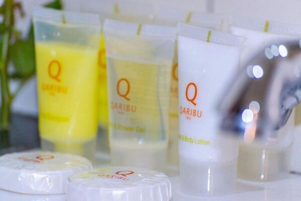 A selection of QARIBU body care products including a shower gel and lotion. - Qaribu Inn Boutique Hotel Nairobi (Nairobi)