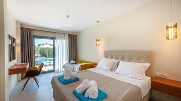 Habitación de hotel con dos camas, un escritorio y vistas a una piscina.