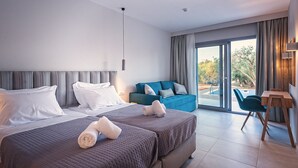 A modern hotel room with two beds, a sofa, a dining table, and a view of a swimming pool. - Alonaki Resort (Preveza)
