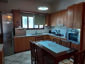 Kitchen with a central island, stainless steel appliances, and a window above the sink.