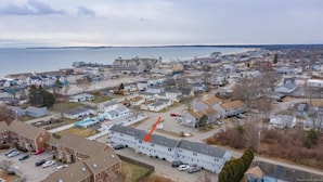 An aerial view of a coastal residential area with houses, a beach, and a large body of water. - 5 Min Walk to Beach and Pier (Old Orchard Beach)