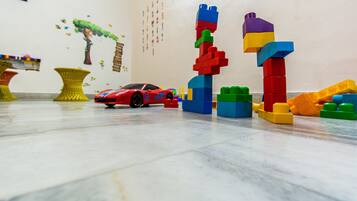 Children can play and learn with building blocks and a toy sports car in this fun play area.