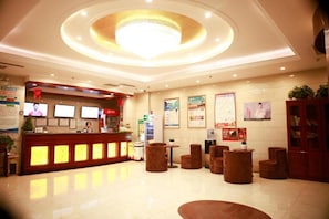 A hotel lobby with a reception desk, seating area, and a chandelier. - Greentree Inn Puyang Fan County People Avenue Banqiao Road Hotel (Puyang)