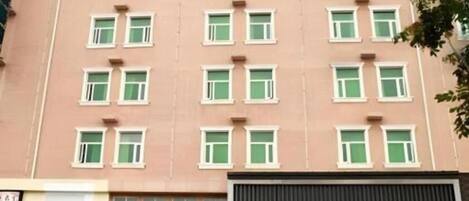 A multi-story building with a uniform facade and rectangular windows.