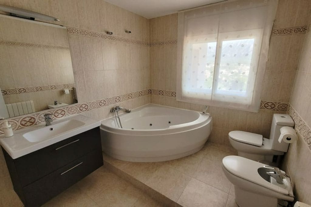 A bathroom with a bathtub, a sink, and a toilet.