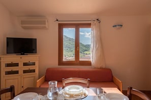 Classic Apartment | Living area | 32-inch flat-screen TV with cable channels, TV - Residence BouganVillage (Budoni)