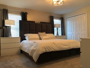 Cozy retreat with a large bed, bedside tables, and a stylish headboard.