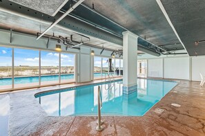 Relax by the pool with a view of the surrounding landscape.