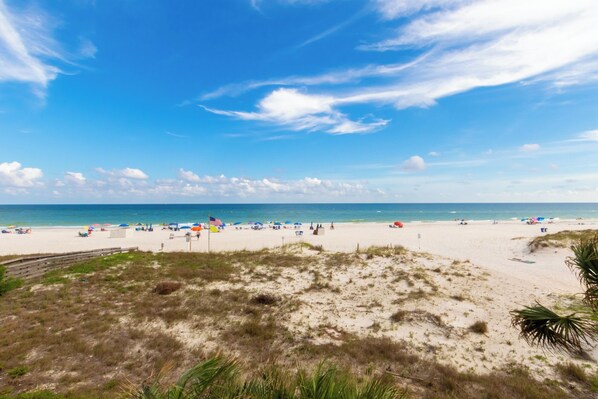 Relax on the sandy shore, where beach umbrellas and lounge chairs invite you to unwind.