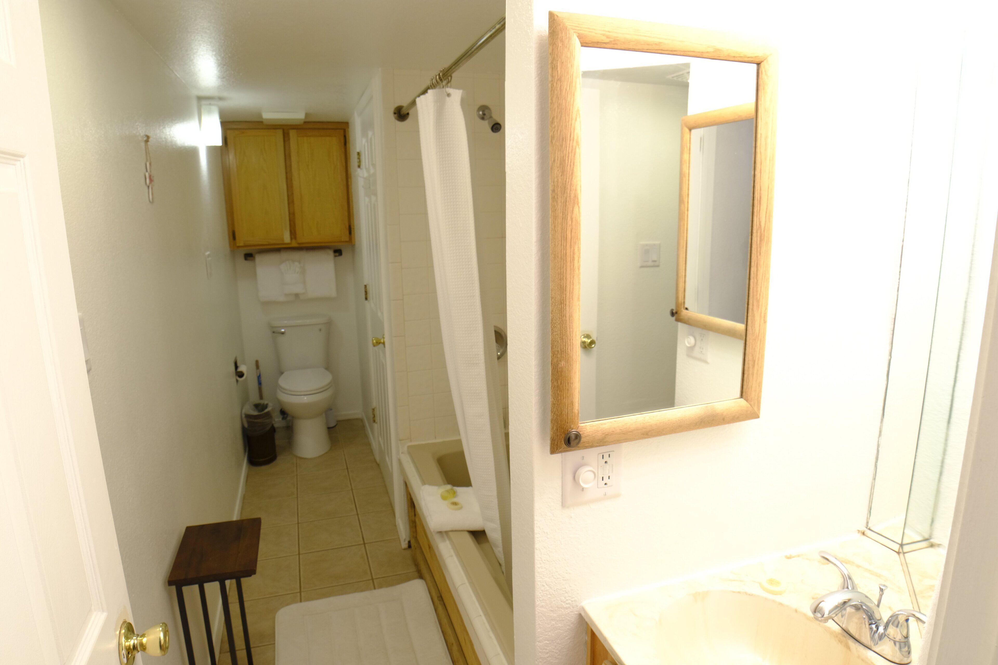 A bathroom with a bathtub, toilet, and sink.