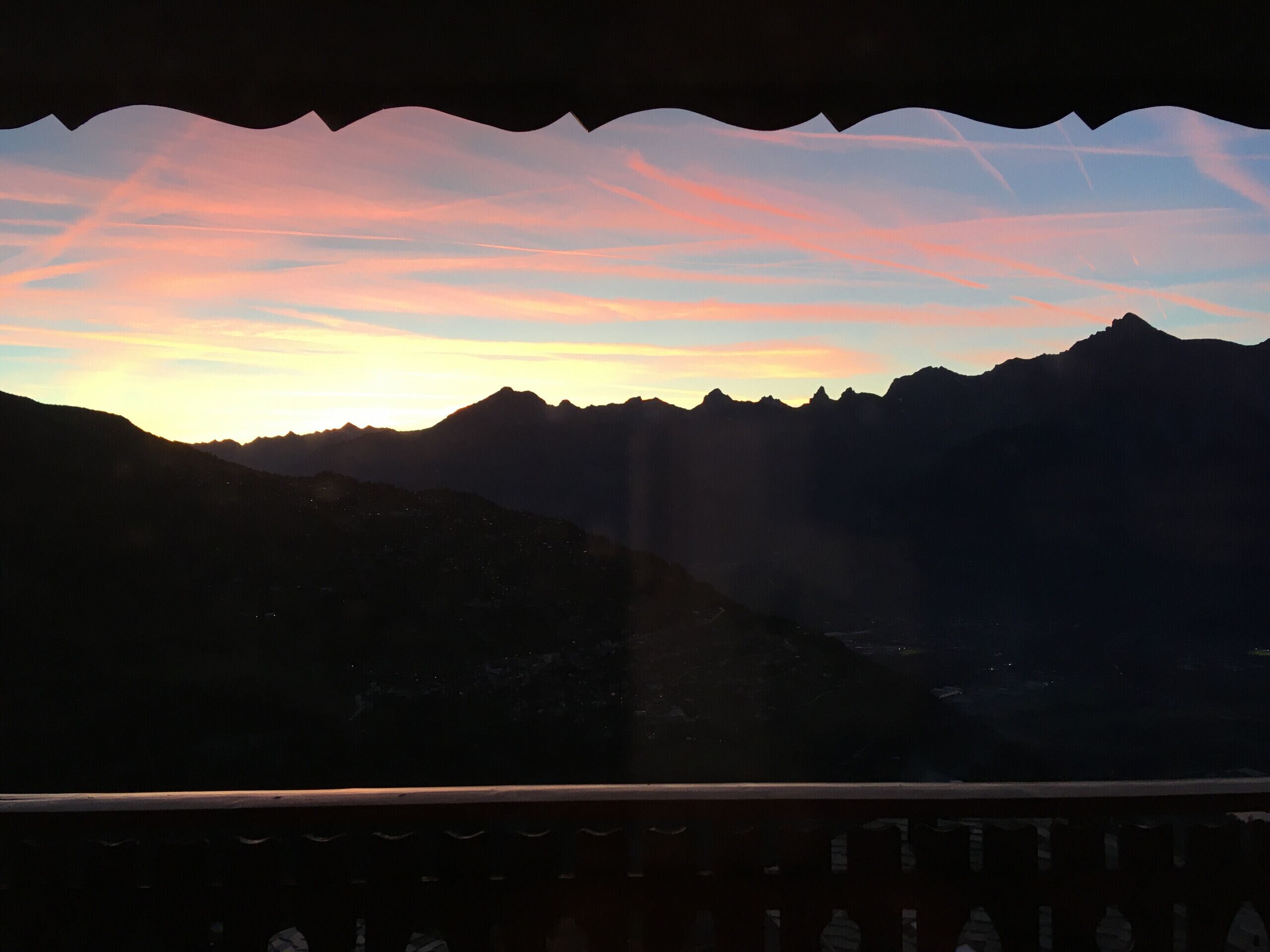 A mountainous landscape with a sunset.