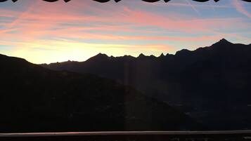 A mountainous landscape with a sunset.