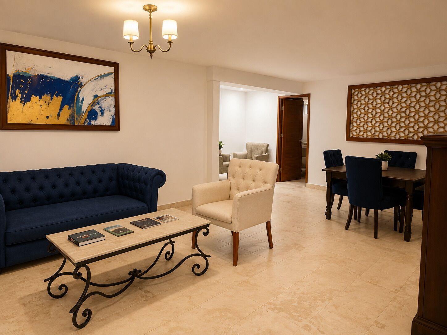 A living room with a blue sofa, a beige armchair, a coffee table, and a dining area with a table and chairs.