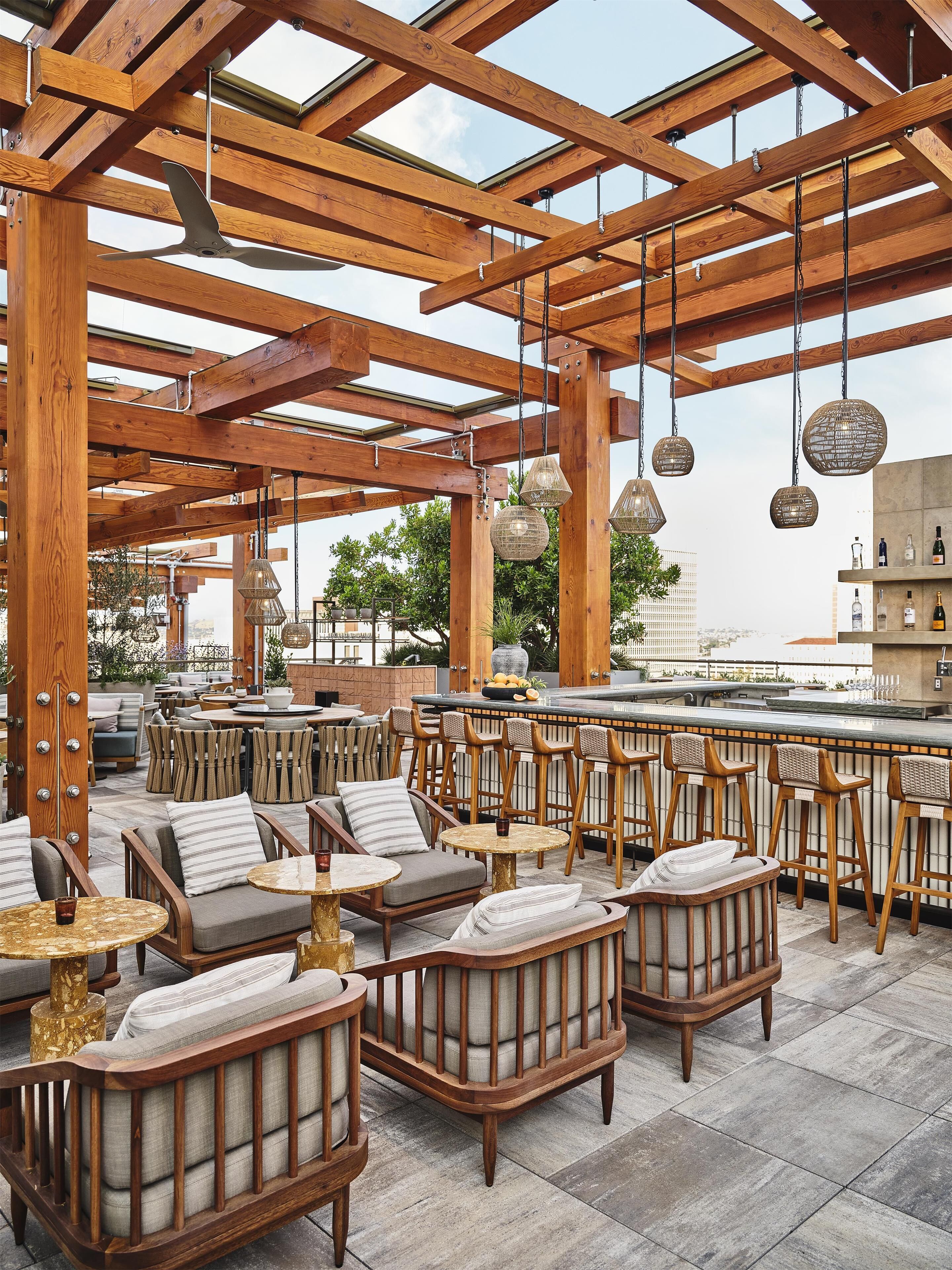 An outdoor seating area with wooden furniture and hanging lights.