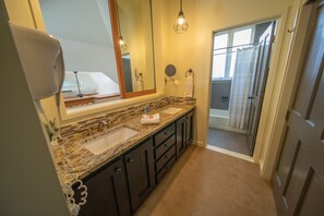 A bathroom with two sinks, a large mirror, and a shower area. - Soda Spring 1917 (Keystone)