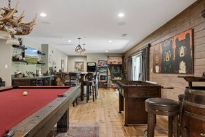 A pool table, bar area, and rustic decor in a room with wooden floors and walls. - Eagle Creek Lodge w/Spa (Big Bear Lake)