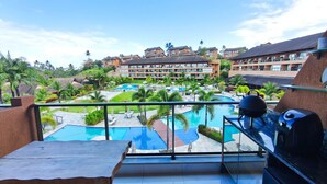 A resort with multiple swimming pools, a barbecue area, and a view of the surrounding buildings. - Eco Resort Praia dos Carneiros (Tamandaré)