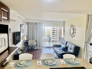Relax in this stylish living area with a flat-screen TV, comfortable sofa, and dining table.