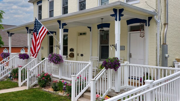 A two-story house with a porch, a flag, and flower boxes. -  Stratton House-Unique Historic District Home-Backs to Culp's Hill-Ski Liberty! (Gettysburg)
