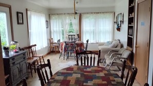 A living room with a dining area, a fireplace, and a bookshelf. - The Bunkhouse @Dragonfly Ranch is made to make you feel like home away from home (Cub Run)