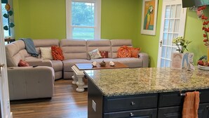 A modern kitchen with dark cabinets, a granite countertop, and a central island.
