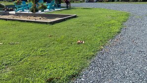 A two-story house with a front porch, a driveway, and a well-maintained lawn.