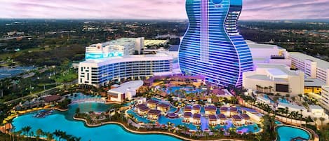 A resort with a guitar-shaped building, multiple swimming pools, and a variety of resort buildings.